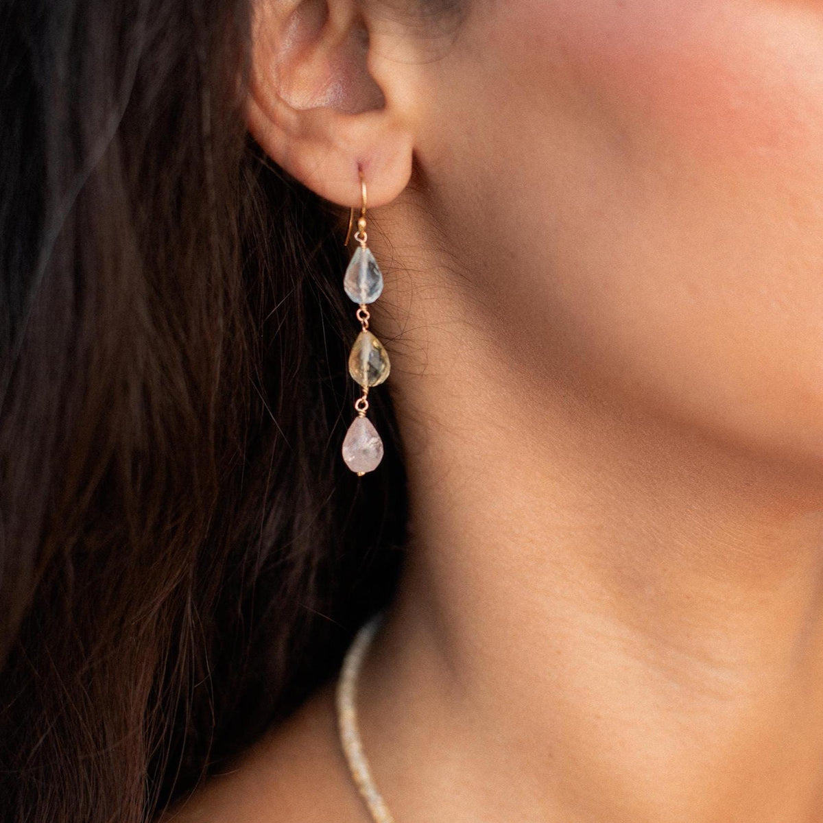 Soft blue, pink, and yellow Morganite earrings by Earthly Abundance featuring delicate gemstone dangles and sterling silver hooks.