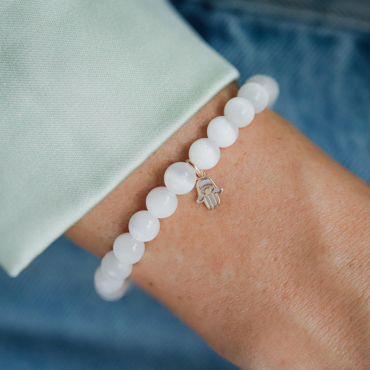 Mother of Pearl Selenite bracelet with 14K gold accents, featuring smooth, polished stones on a delicate jewelry strand.