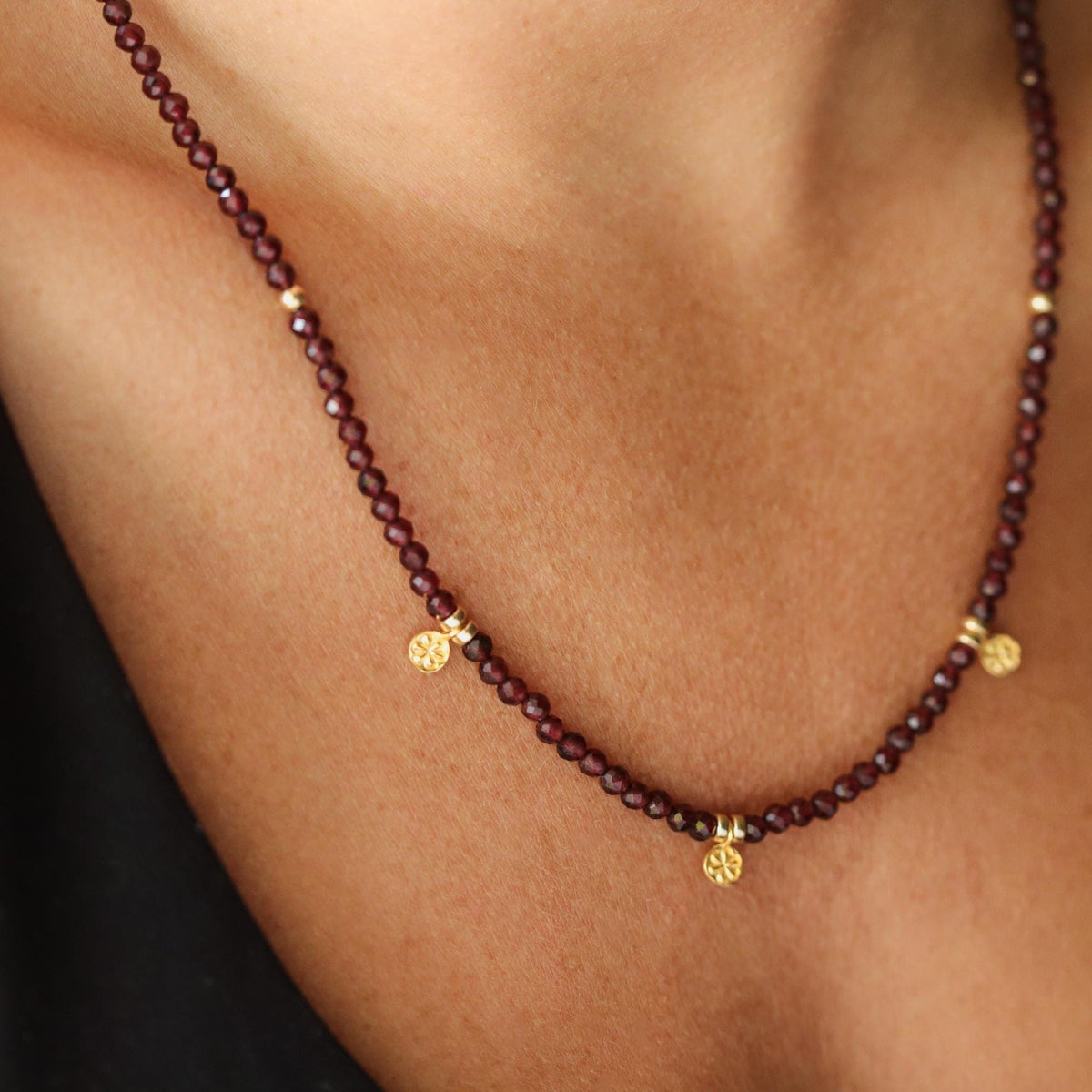 Garnet beaded necklace from Earthly Abundance Jewelry featuring deep red gemstone beads on a delicate string.