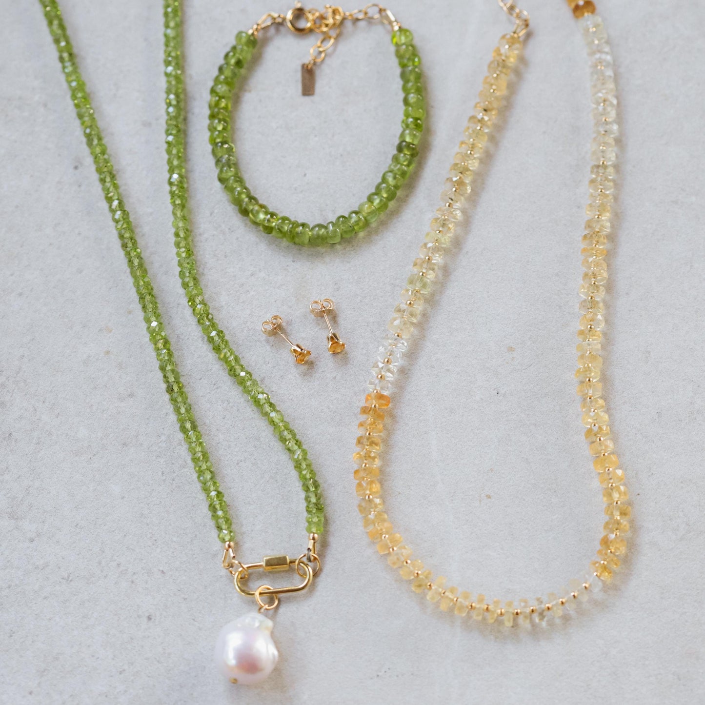 Peridot and pearl carabiner necklace by Earthly Abundance, featuring vibrant green gemstones and elegant pearl accents.