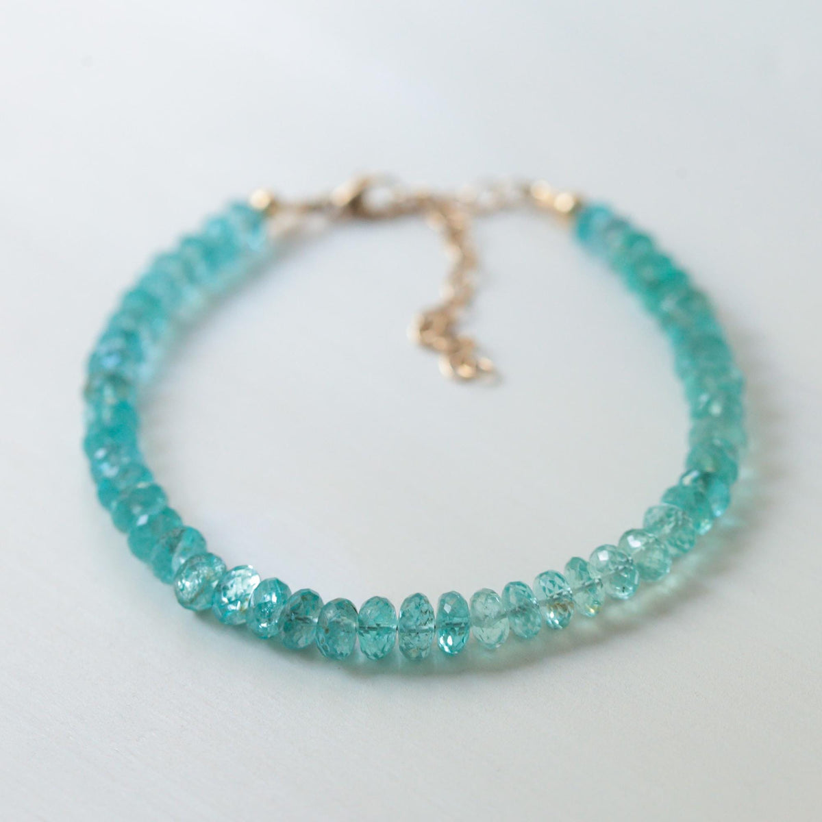 Earthly Abundance Ocean Light Apatite bracelet featuring polished blue-green apatite stones on an elastic cord.
