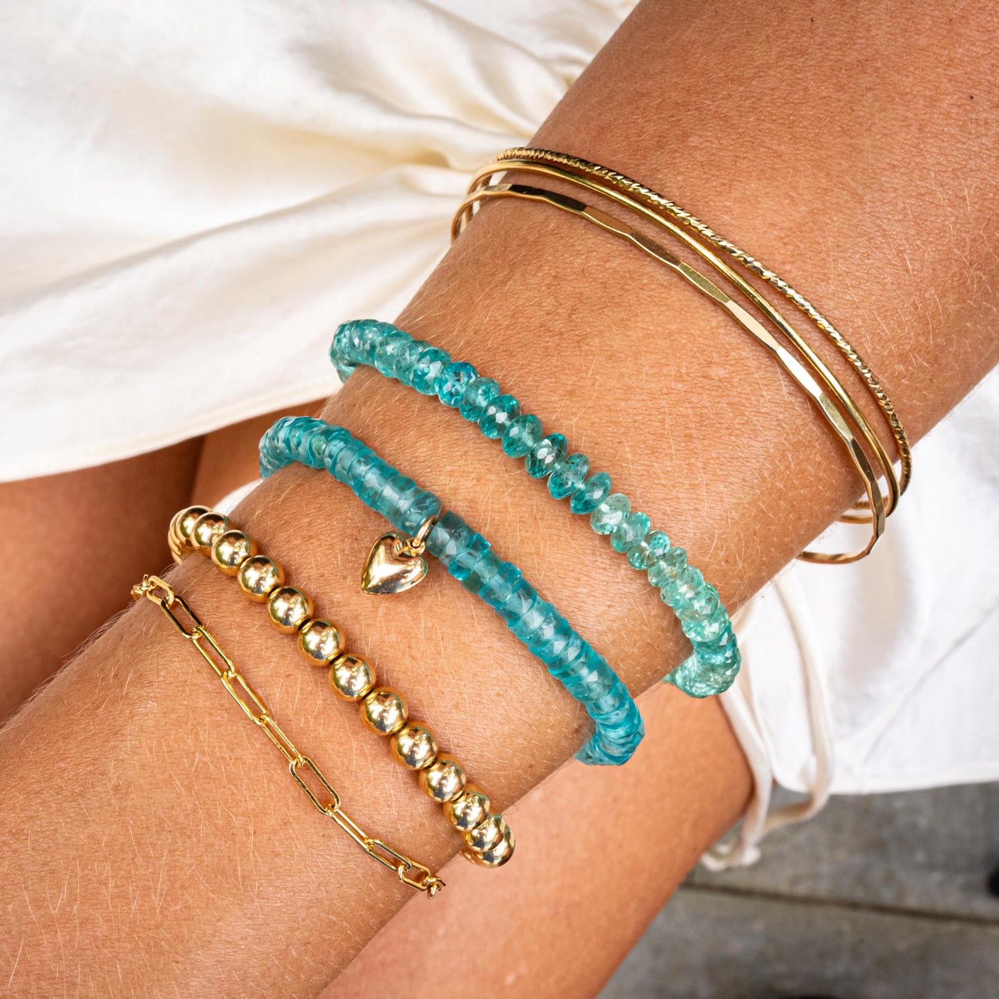 Earthly Abundance Ocean Light Apatite bracelet featuring polished blue-green apatite beads on an elastic band.