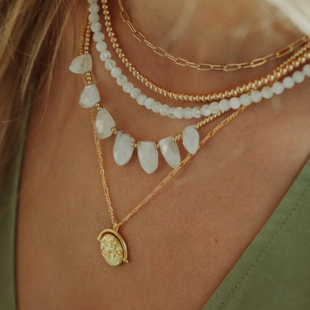 Seven moonstone drop necklace featuring a delicate chain and a luminous moonstone pendant, crafted by Earthly Abundance Jewelry.