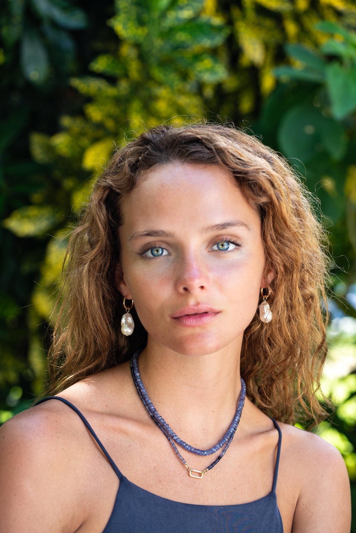 Indigo Muse Tanzanite Necklace featuring deep blue tanzanite stones on a silver chain from Earthly Abundance Jewelry