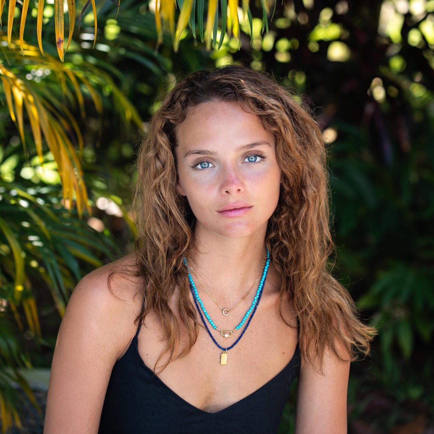 Lapis lazuli beaded necklace by Earthly Abundance featuring vibrant blue stones with gold-toned accents.