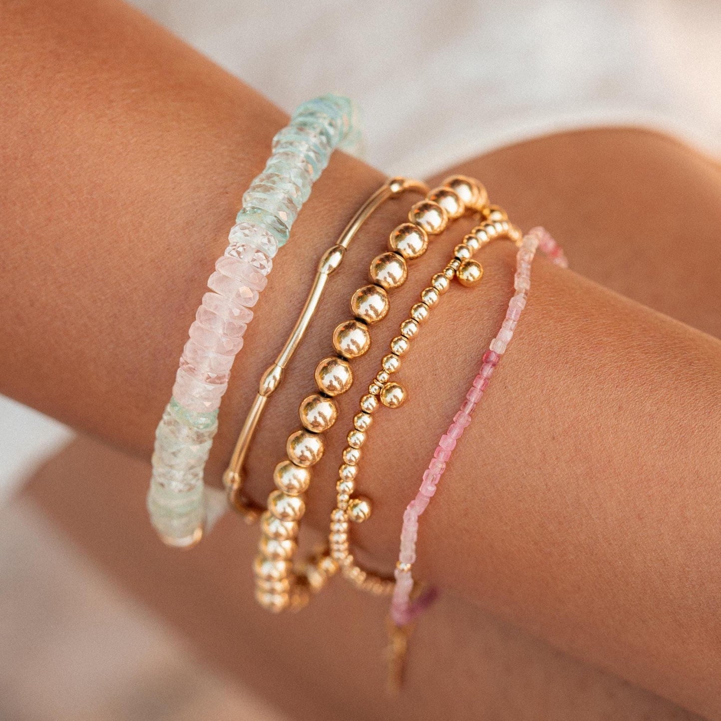 Elegant sweetheart bracelet featuring Morganite, Aquamarine, and White Topaz gemstones with intricate silver detailing.