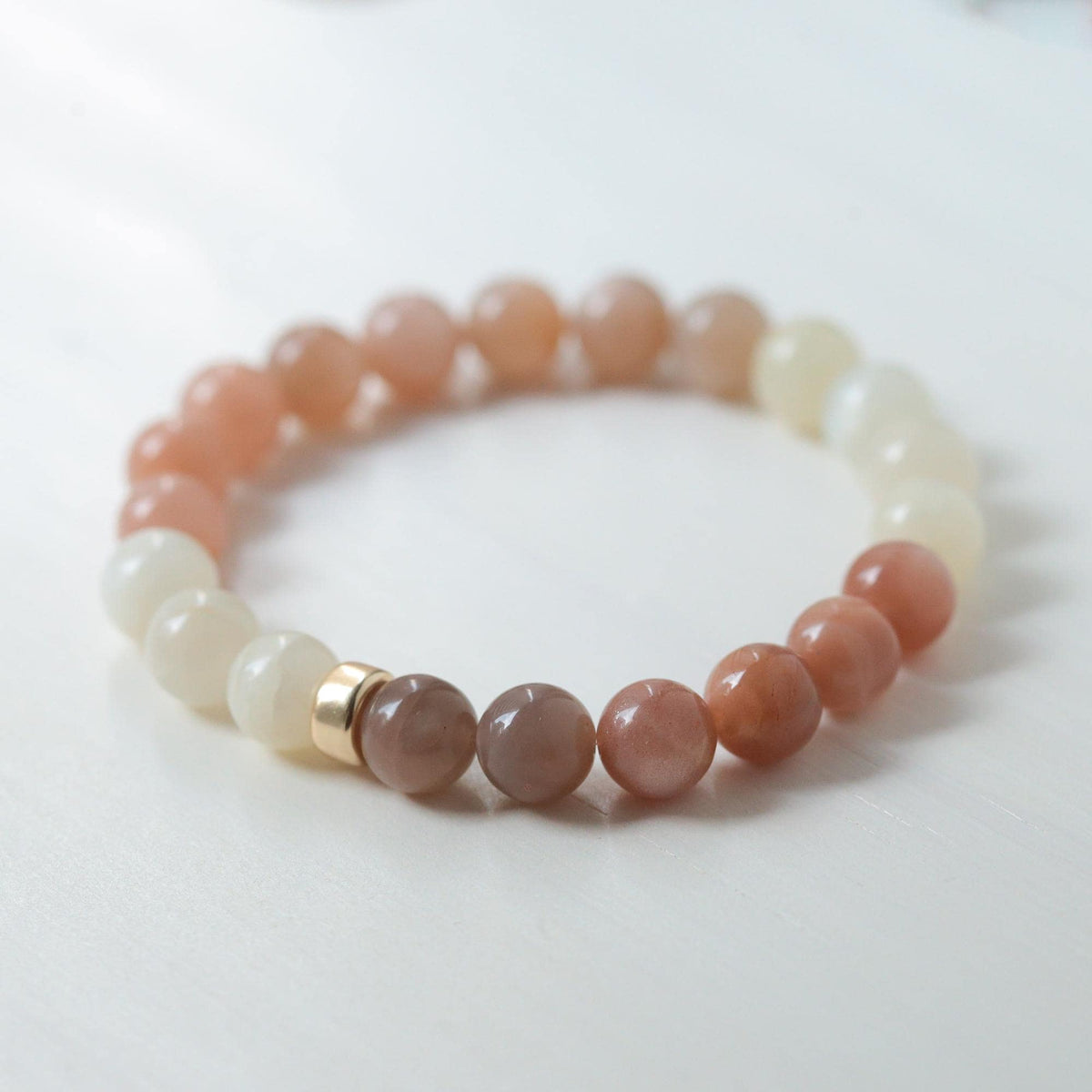 Earthly Abundance Desert Moon Bracelet featuring a moon-shaped pendant on a delicate chain, displayed against a neutral background.