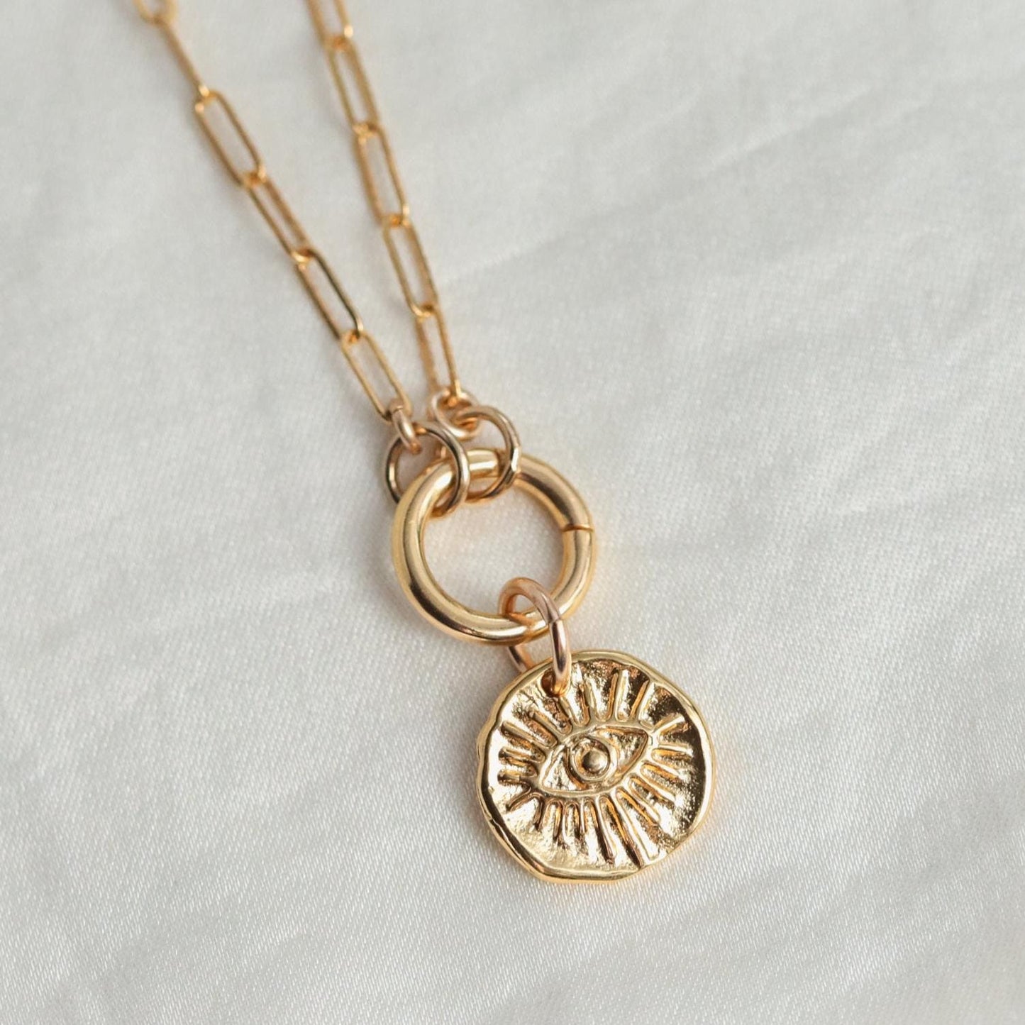Earthly Abundance evil eye necklace set featuring a delicate chain with a vibrant blue eye pendant on a white background