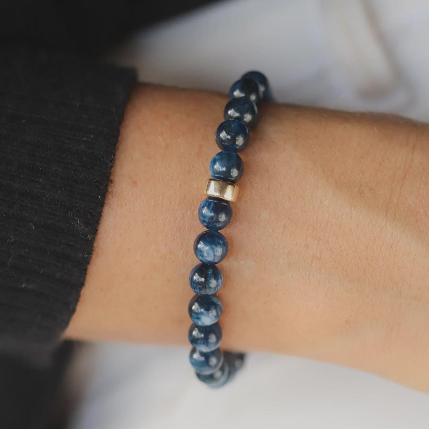 Kyanite bracelet with polished blue stones on a black cord, featuring silver clasp, by Earthly Abundance Jewelry.