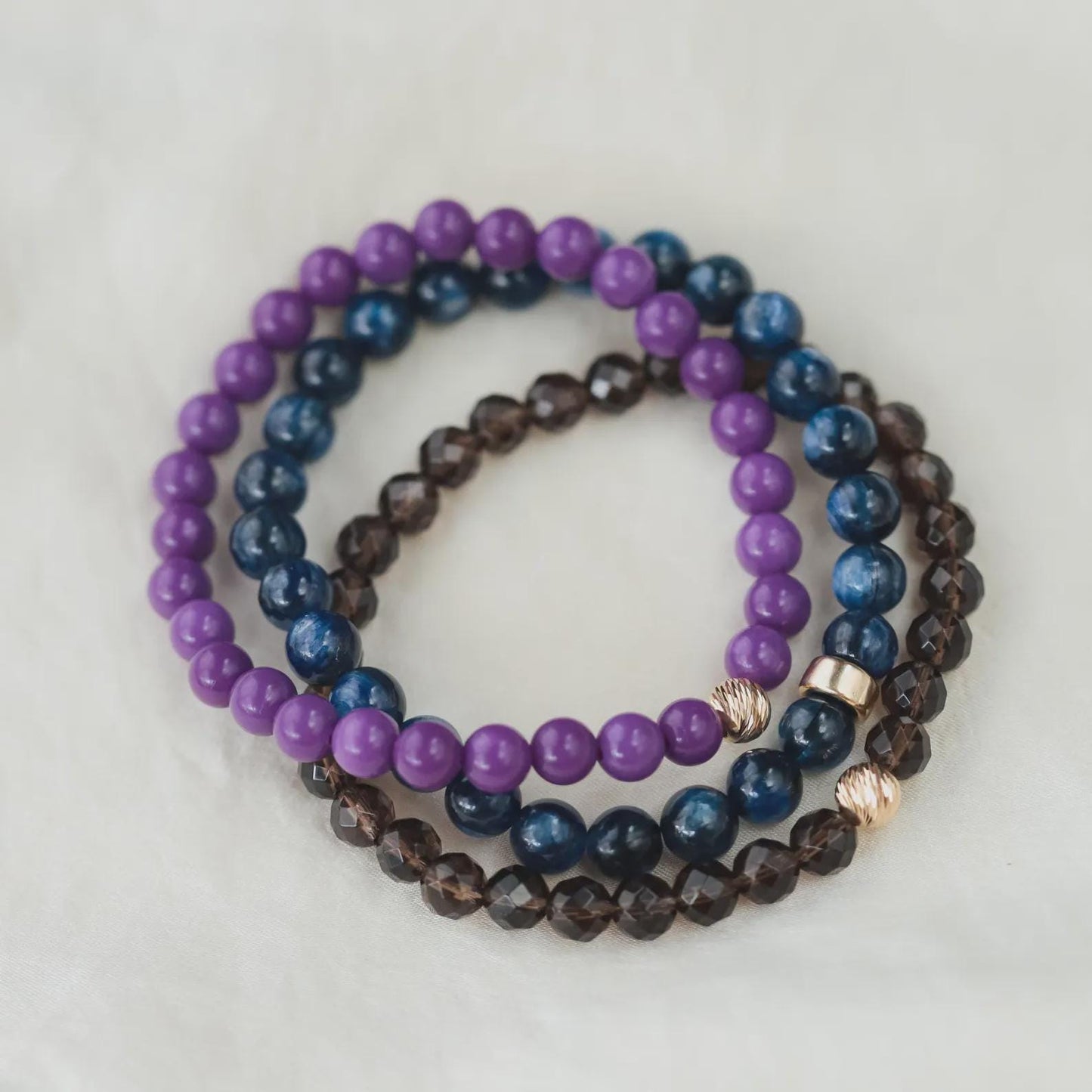 Kyanite bracelet with polished blue stones from Earthly Abundance Jewelry, featuring a stretchy elastic band on a white background.
