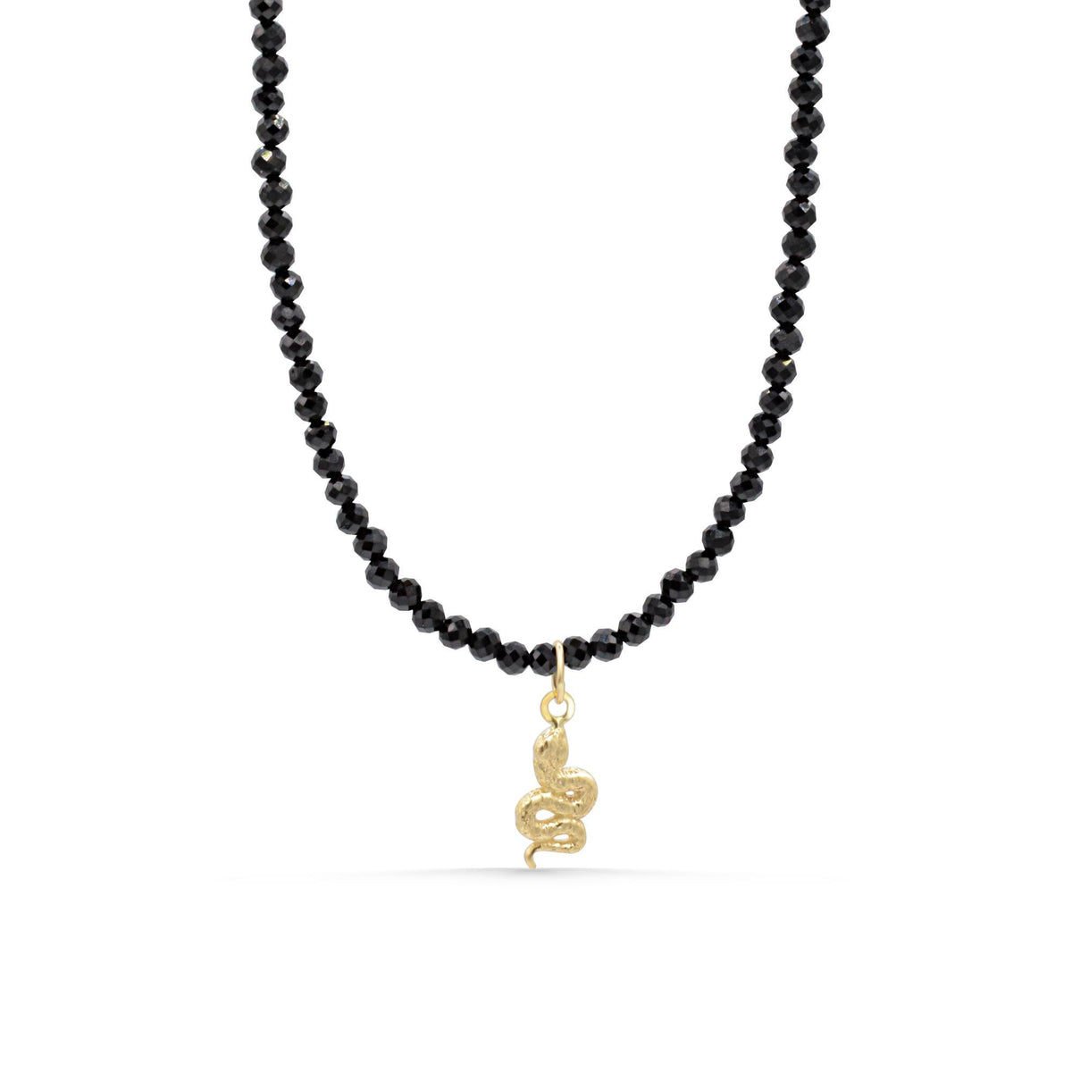 Black tourmaline snake necklace crafted with 14K gold from Earthly Abundance, featuring a detailed snake pendant on a chain.