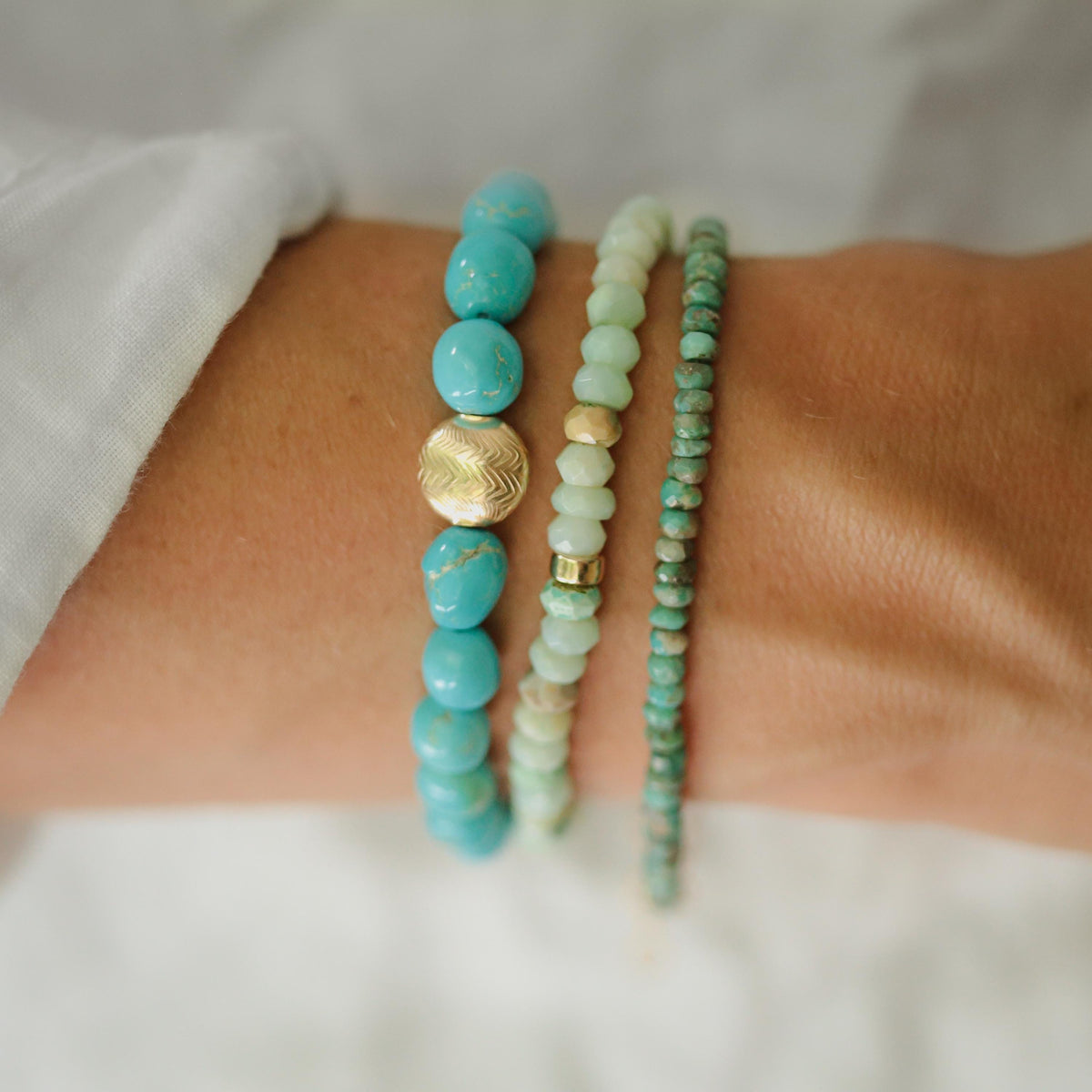 Earthly Abundance Arizona turquoise beaded bracelet with vibrant blue stones and silver accents on a neutral background.