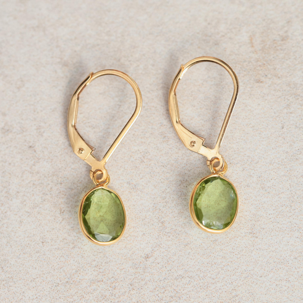 Peridot leverback earrings in 14K gold from Earthly Abundance, featuring vibrant green gemstones and secure leverback clasps.