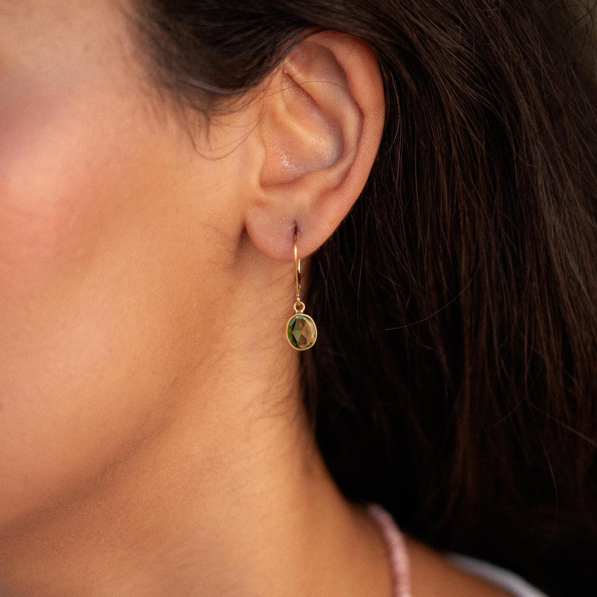 Peridot leverback earrings in 14K gold featuring vibrant green peridot gemstones and secure leverback closures.