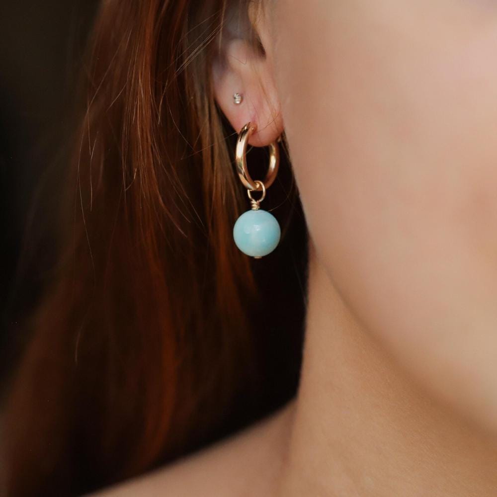 Hemimorphite hoop earrings with 14K gold filled finish, featuring vibrant blue-green gemstones and gold-filled hoop design.