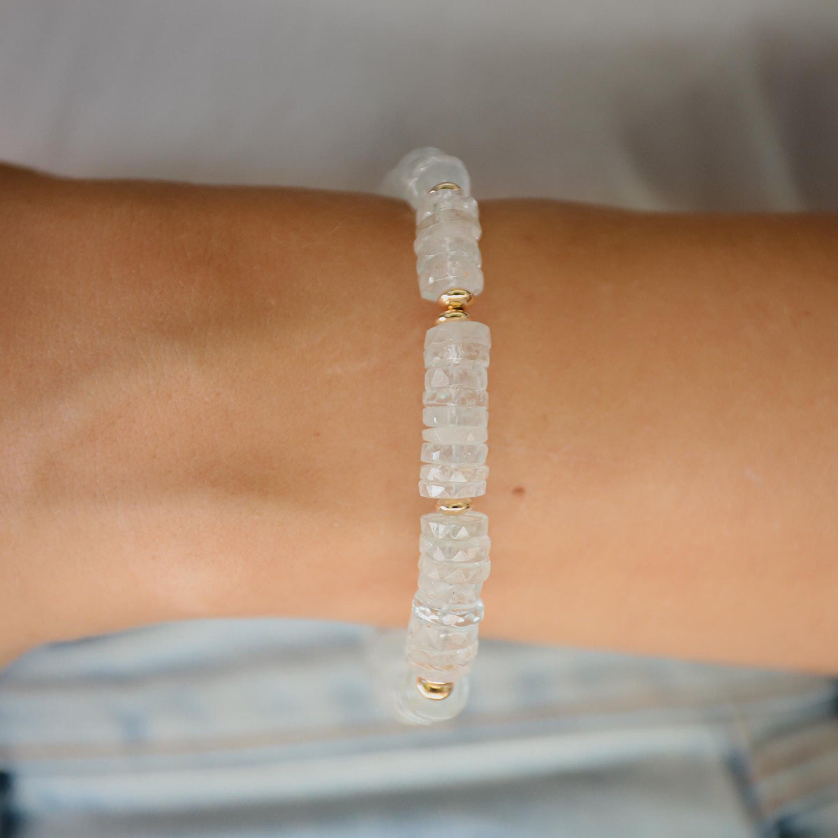 Blue Topaz Heishi bracelet with small round blue gemstone beads on an elastic cord, crafted by Earthly Abundance.