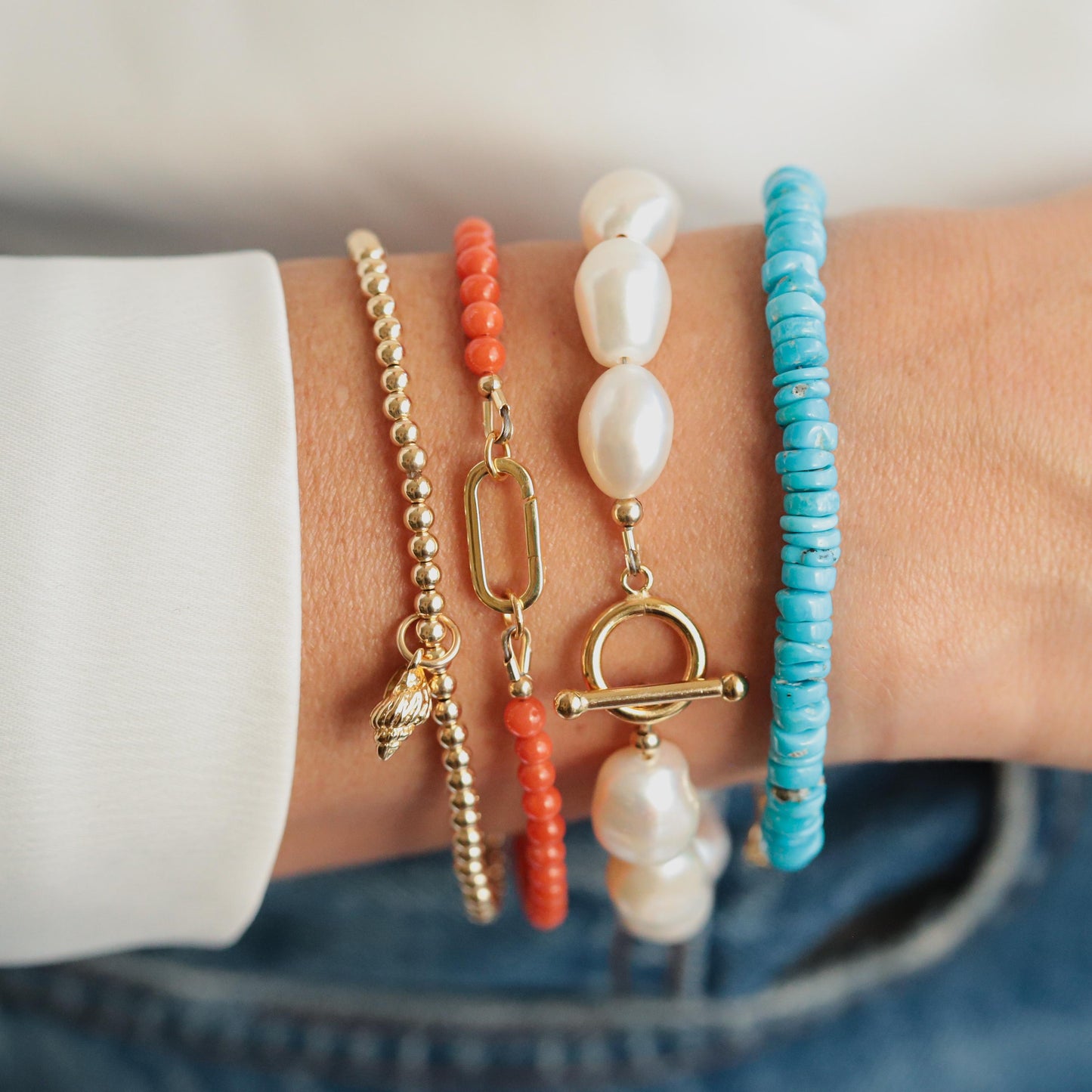 Earthly Abundance conch shell bracelet featuring natural beige and white conch shells on an elastic band, bohemian jewelry accessory.