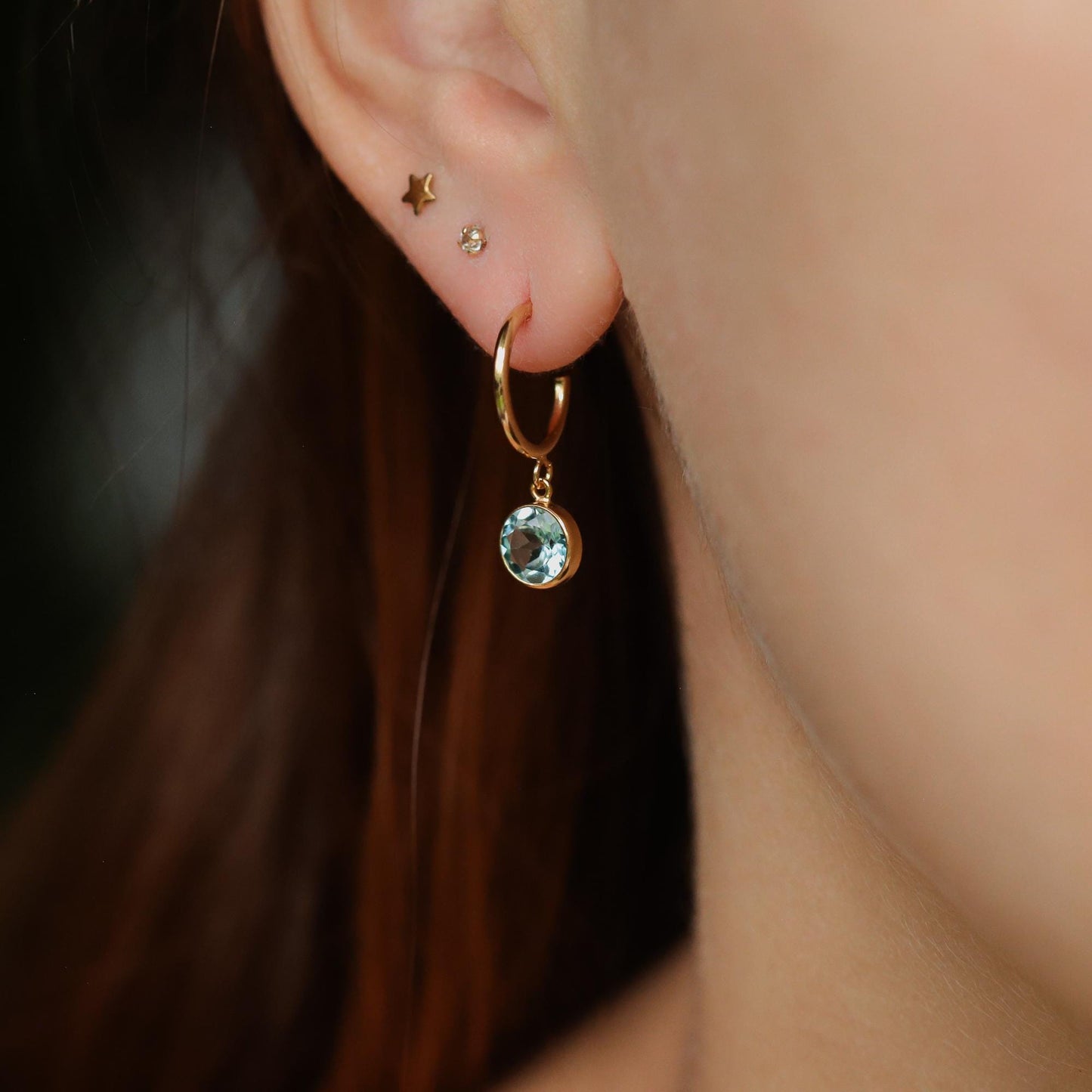 Sky blue topaz earrings with 14K gold-filled settings, featuring elegant gemstone dangles on a white background
