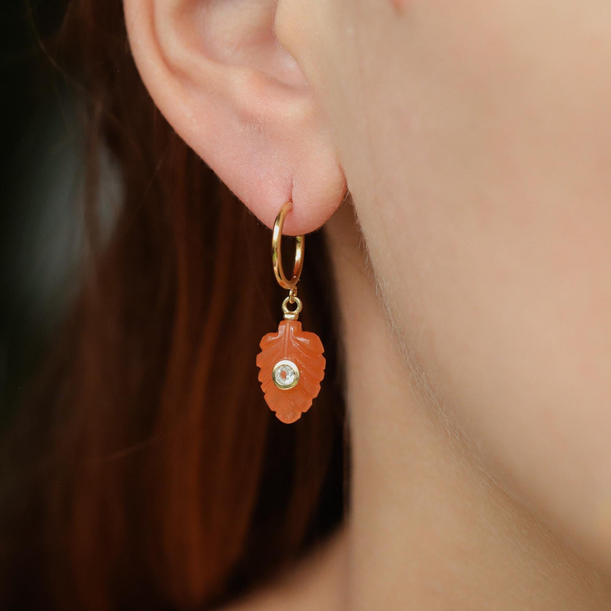Earthly Abundance Carnelian White Topaz earrings featuring vibrant orange stones and sparkling white topaz accents on silver hooks.