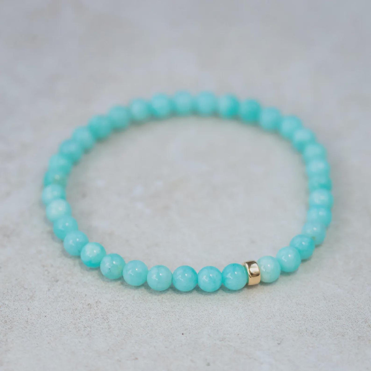 Peruvian Amazonite bracelet with 5mm beads from Earthly Abundance, showcasing vibrant blue-green stones on a white background.