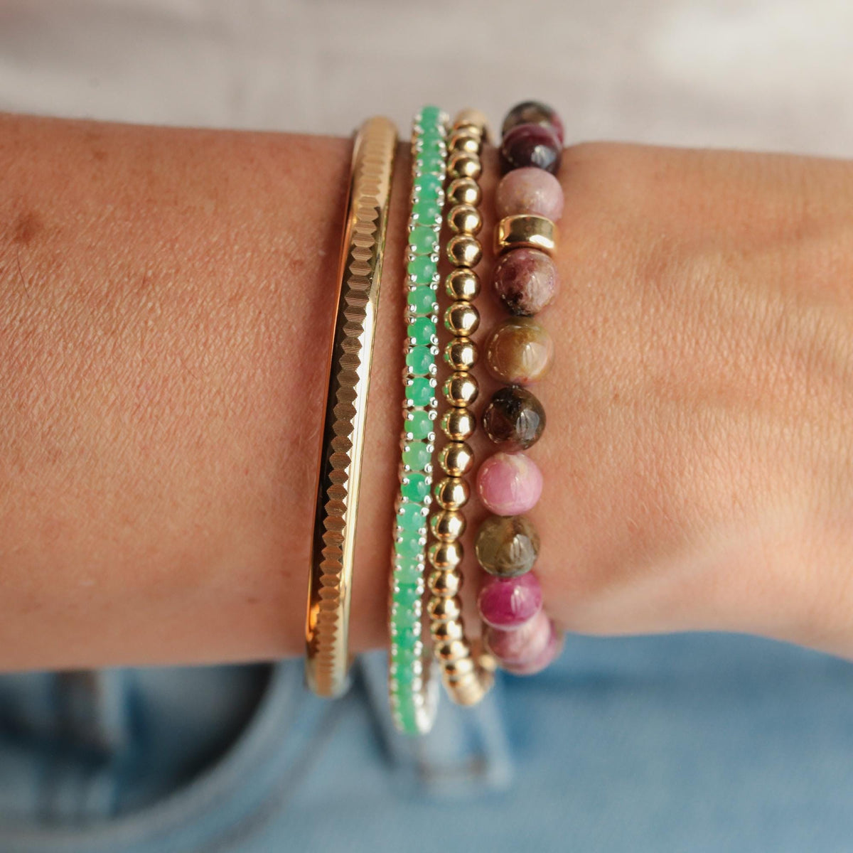Dusty rose pink tourmaline bracelet with 14K gold accents from Earthly Abundance Jewelry, featuring polished pink gemstone beads.