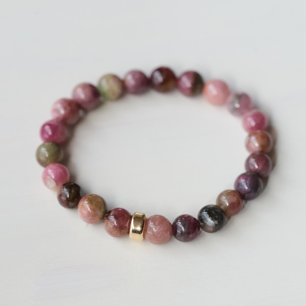 Dusty rose pink tourmaline bracelet crafted with 14K gold from Earthly Abundance Jewelry, featuring polished gemstone beads.