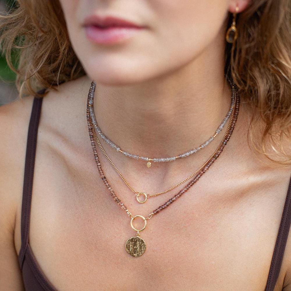 Elegant zircon necklace from Earthly Abundance featuring a timeless radiance design with sparkling stones on a delicate chain.
