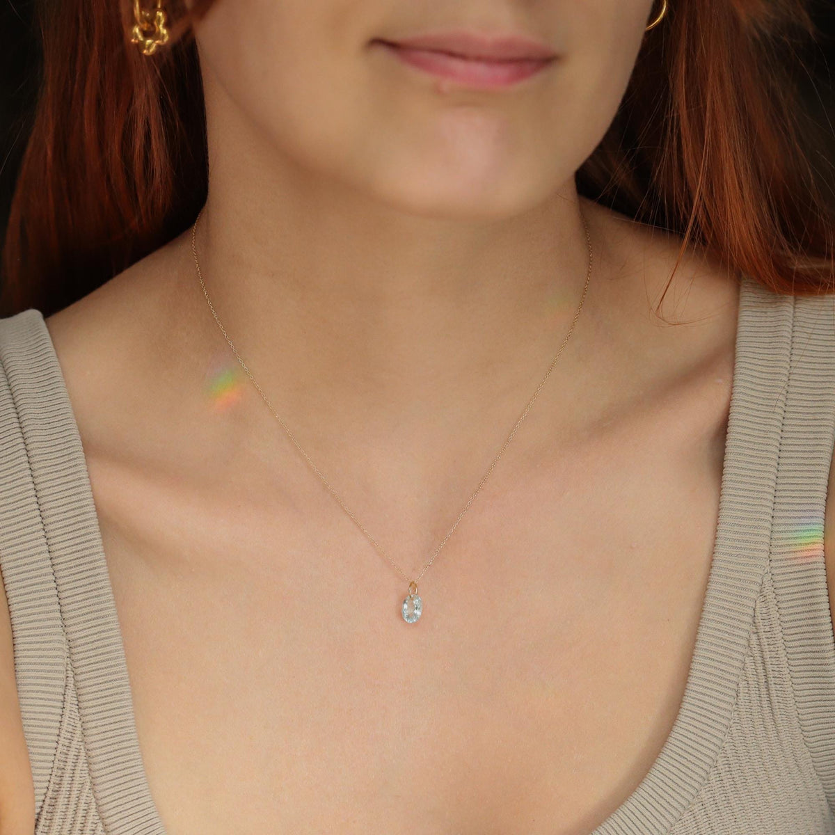 Aquamarine pendant necklace with 14K gold setting, featuring a sparkling aquamarine gemstone on a delicate chain.