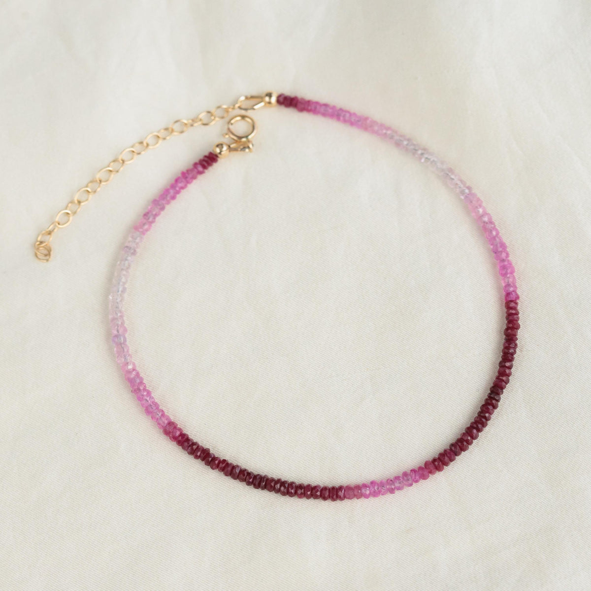 Raspberry Mist Ruby Anklet by Earthly Abundance featuring 14K gold chain and ruby gemstone accents on a delicate anklet.