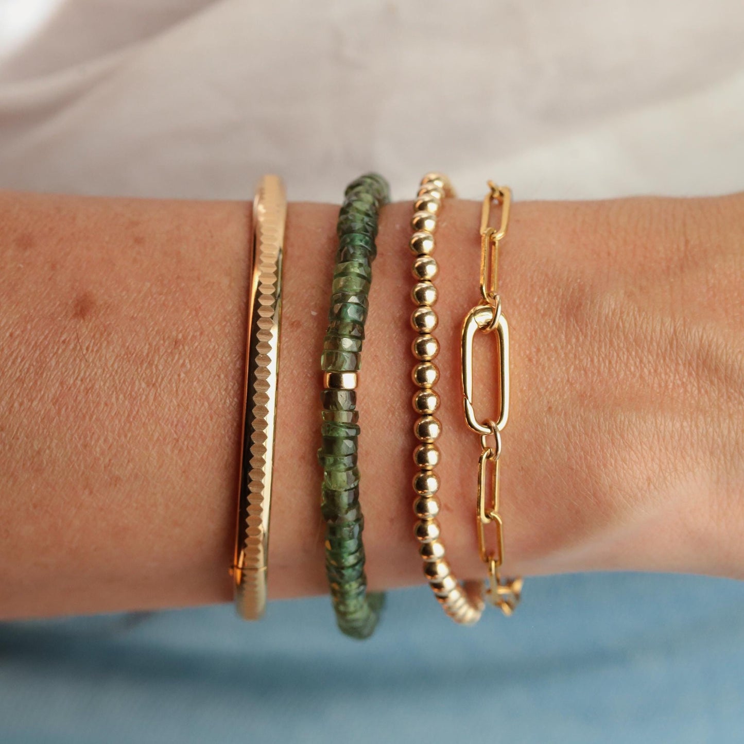 Green Apatite Heishi bracelet by Earthly Abundance featuring small, round green stone beads on a stretch cord.