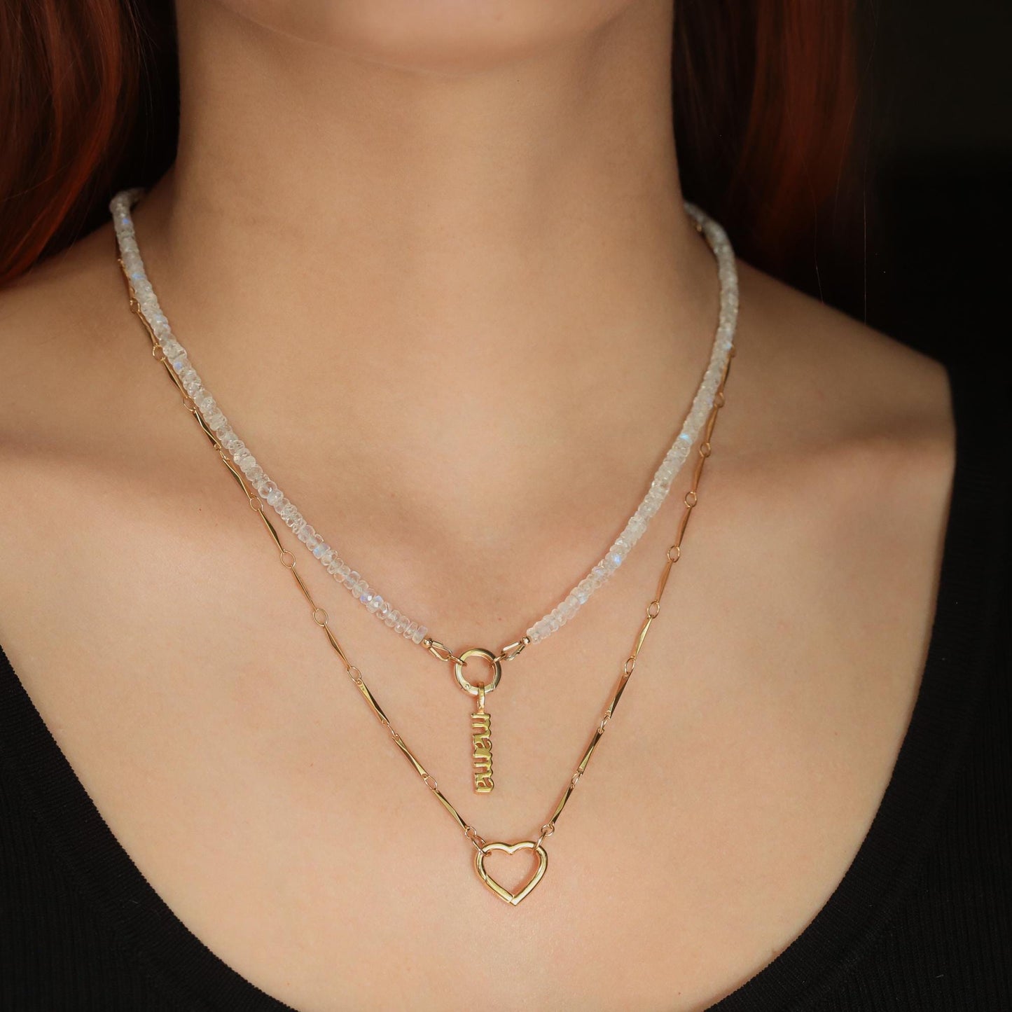 Rainbow Moonstone carabiner necklace featuring a polished moonstone pendant on a metal chain, stylish and elegant jewelry accessory.