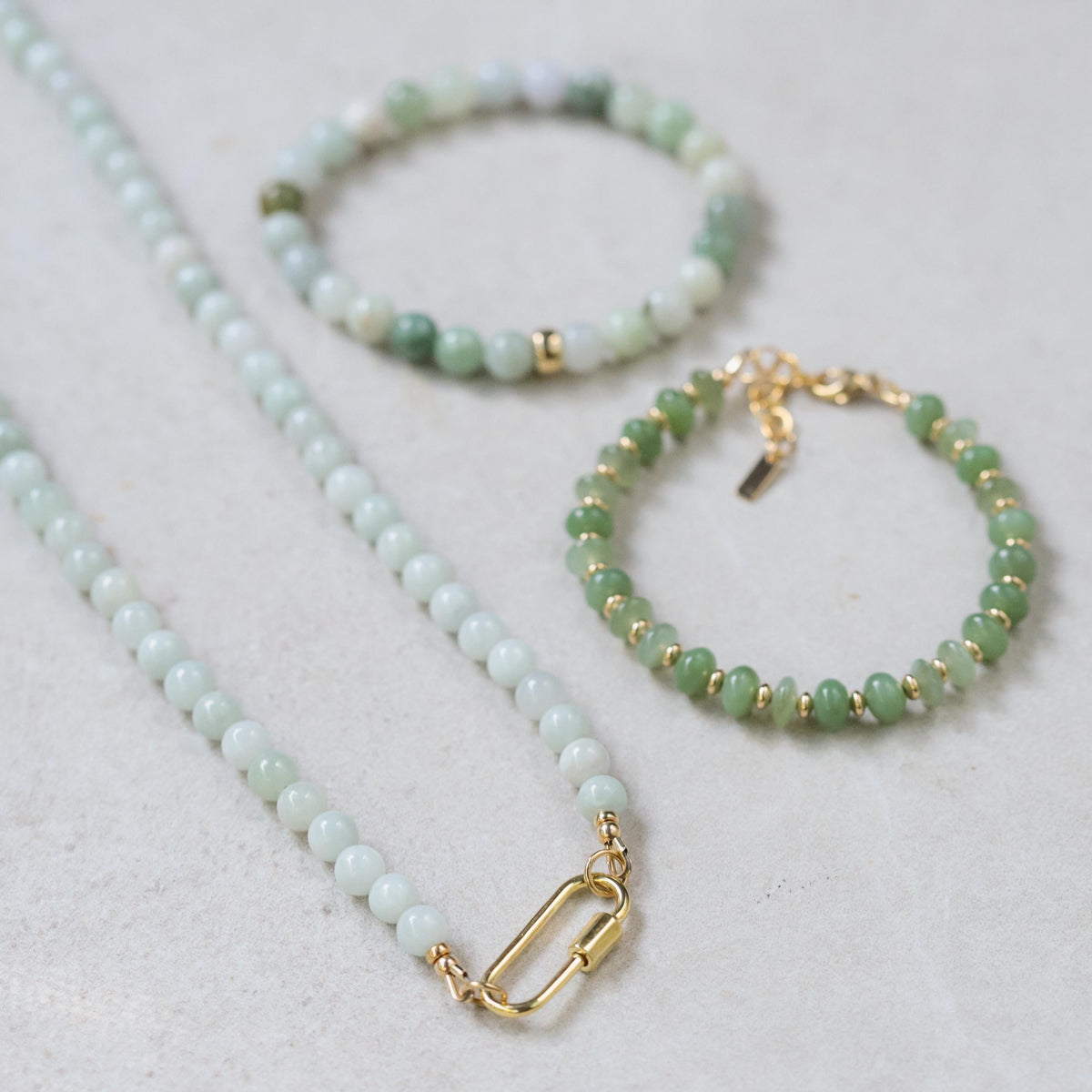 Burmese Jade 6mm beads from Earthly Abundance, showcasing smooth, polished green jade gemstones arranged in a string.