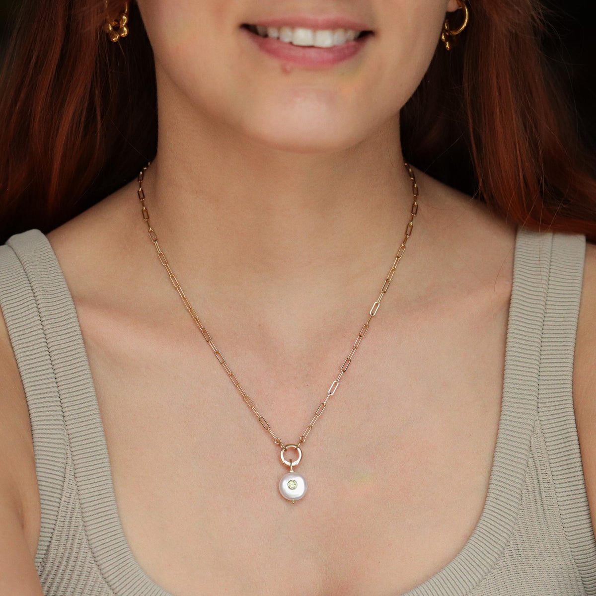 Earthly Abundance Solace Pearl Peridot Necklace featuring a pearl and peridot gemstone pendant on a delicate chain.