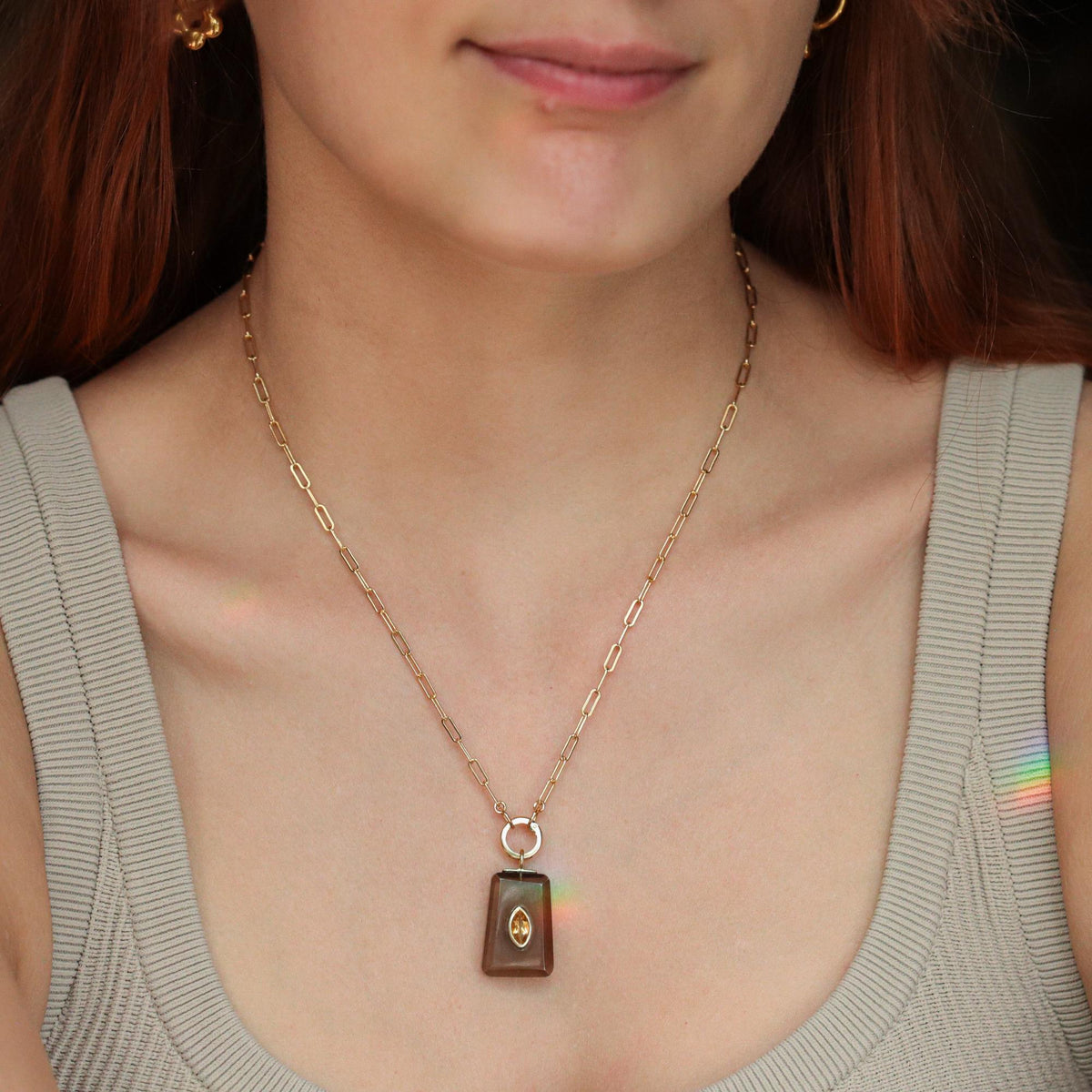 Golden Depth Smoky Quartz Necklace featuring a large, polished smoky quartz pendant on a delicate chain by Earthly Abundance.