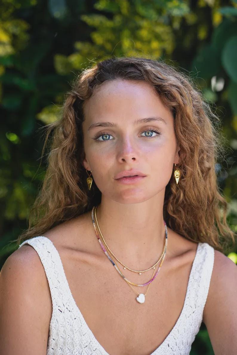 Elegant Etherea Pearl Necklace by Earthly Abundance featuring lustrous white pearls on a delicate chain.