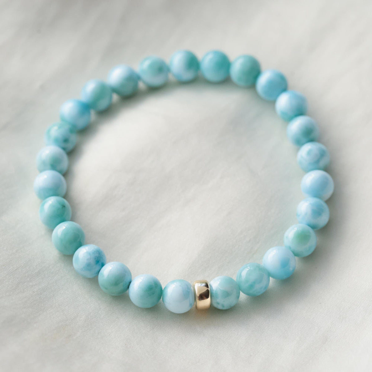 Rare Beauty Larimar bracelet by Earthly Abundance featuring smooth blue larimar beads on an elastic stretch band.