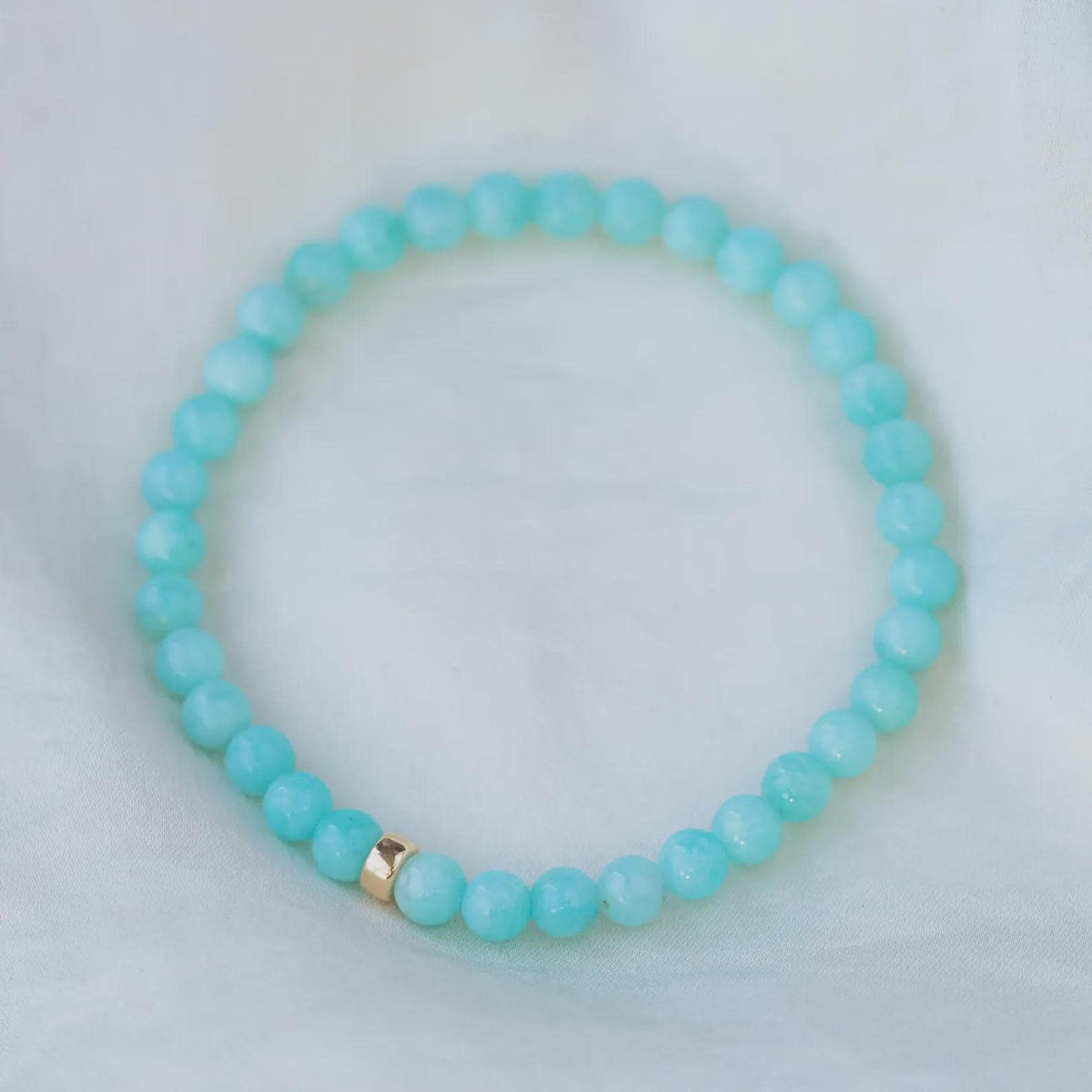 Peruvian Amazonite bracelet with 5mm beads from Earthly Abundance, showcasing smooth, turquoise-green stones on a neutral background.
