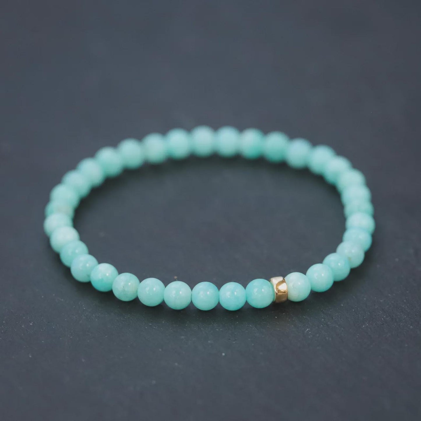 Peruvian Amazonite bracelet with 5mm beads from Earthly Abundance, showcasing smooth, blue-green gemstone stones on a neutral background.