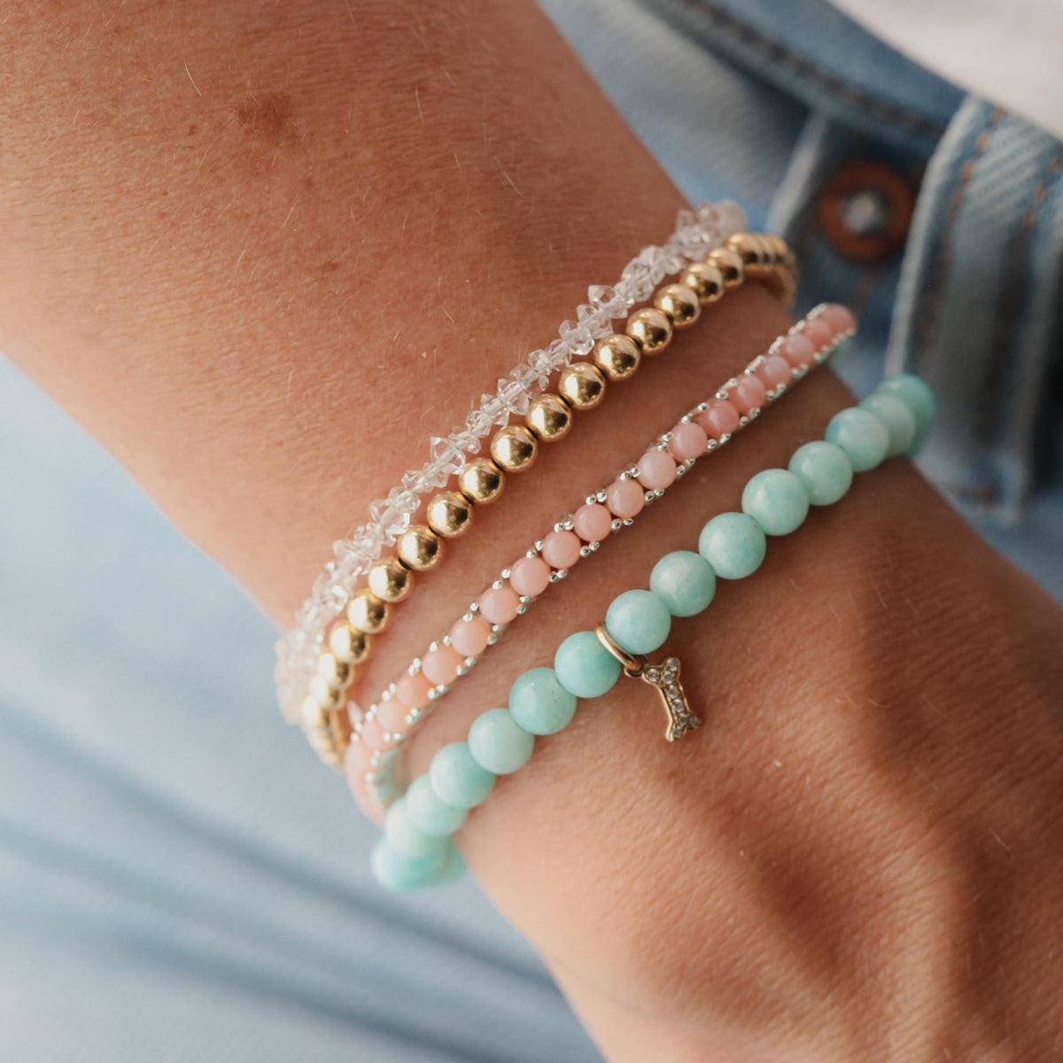 14K diamond dog bone charm bracelet by Earthly Abundance featuring a sparkling dog bone pendant on a delicate chain.