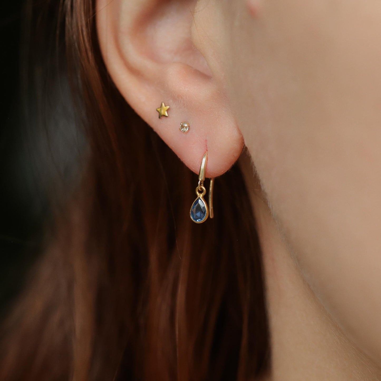 Blue sapphire drop earrings in 14K gold from Earthly Abundance, featuring elegant blue sapphires hanging from gold hooks.