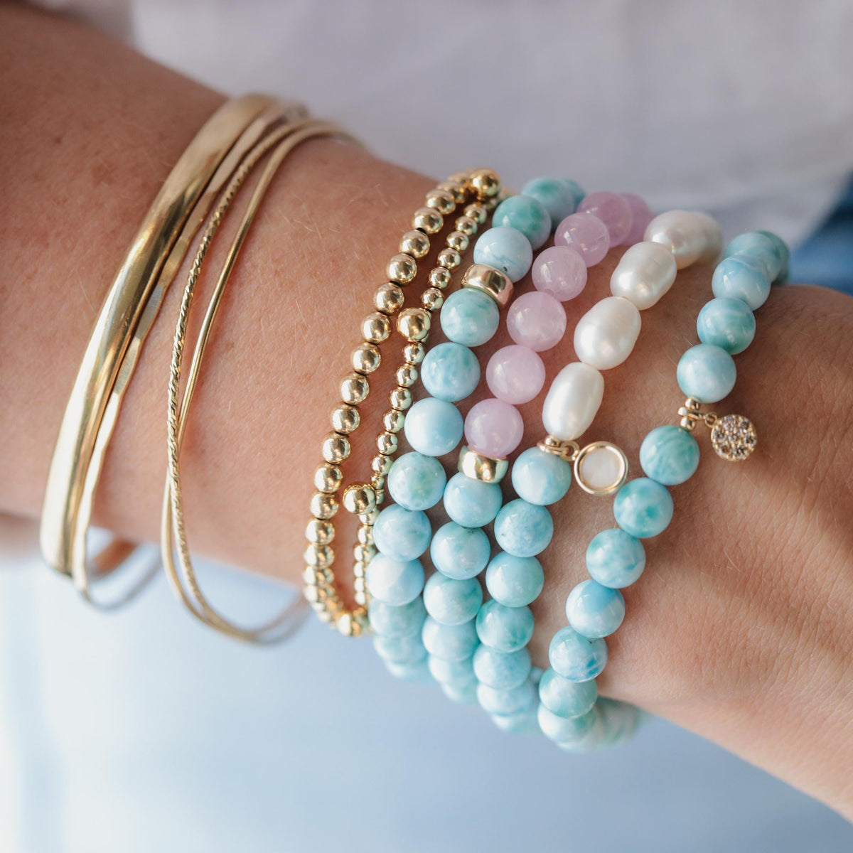 Ocean Calm Larimar and Kunzite bracelet featuring blue Larimar and pink Kunzite beads on a delicate elastic band.