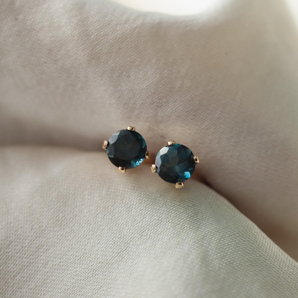 London Blue Topaz stud earrings featuring vibrant blue gemstones set in silver, designed by Earthly Abundance.