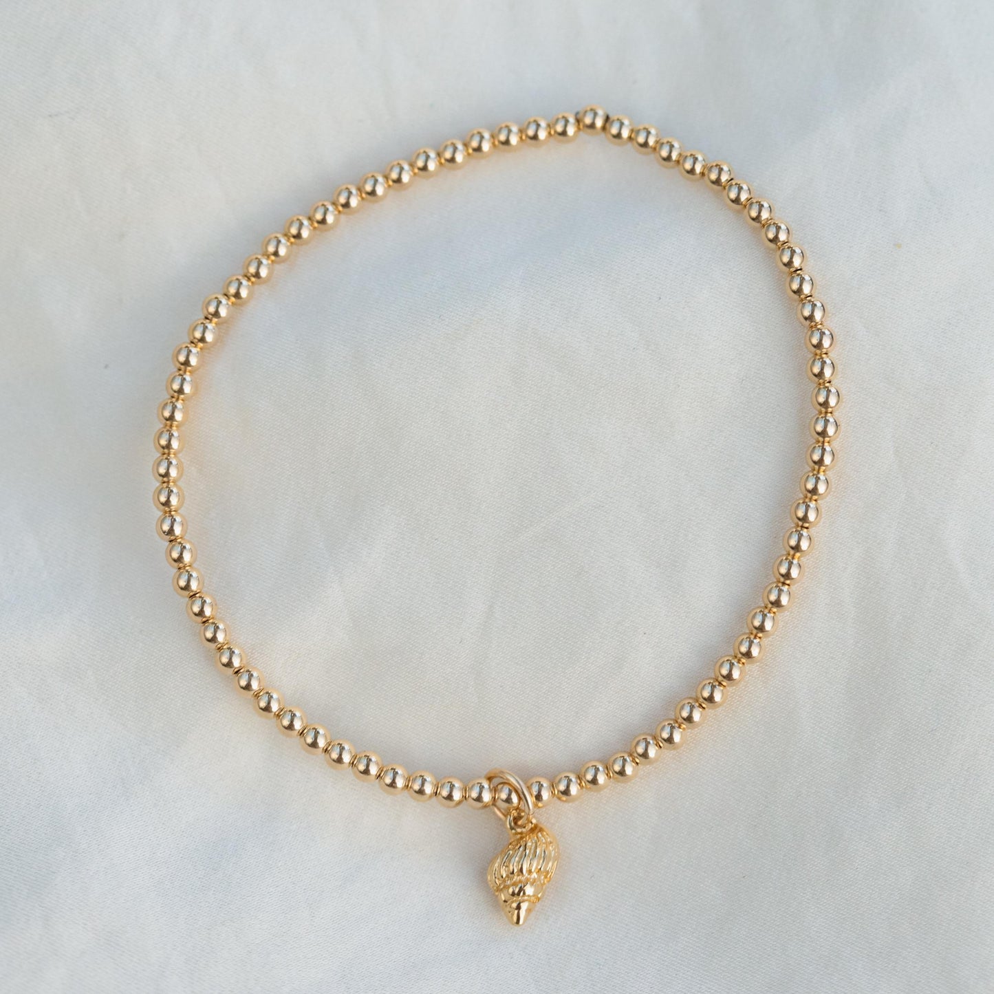 Conch shell bracelet from Earthly Abundance featuring natural shell beads and adjustable cord for a bohemian style accessory.