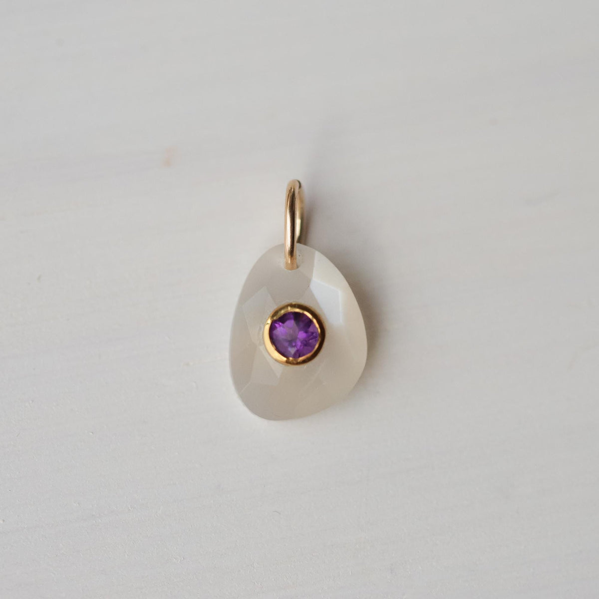 Lilac moon pendant featuring moonstone and amethyst gemstones from Earthly Abundance, shown hanging on a delicate chain.