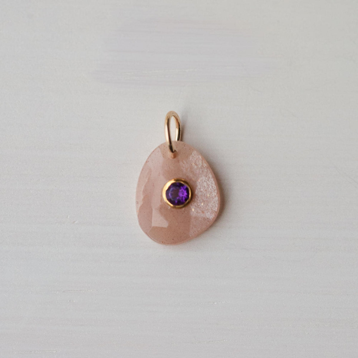 Dawn Muse pendant by Earthly Abundance featuring peach moonstone and amethyst gemstones in a delicate silver setting.