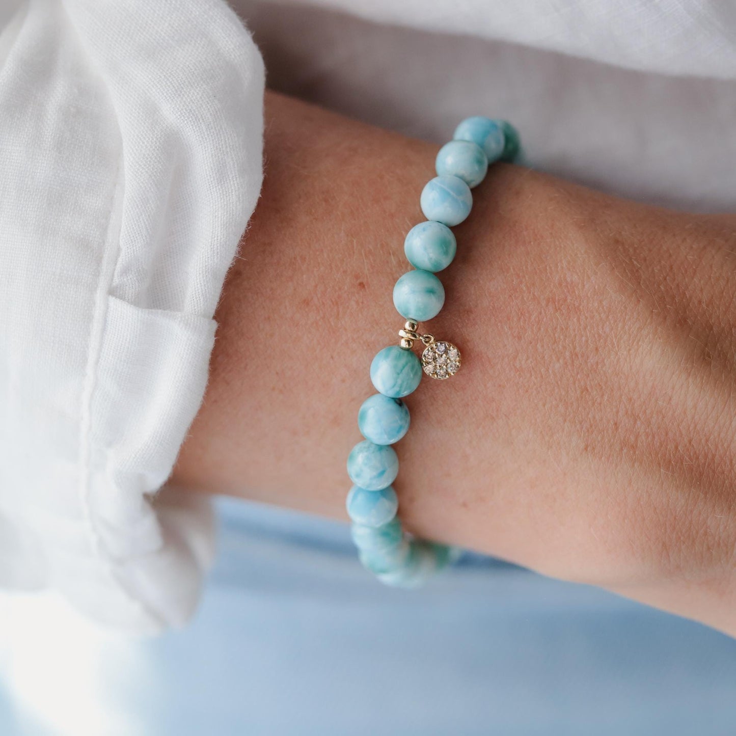 Larimar and diamond bracelet by Earthly Abundance featuring a delicate silver chain with blue larimar stones and sparkling diamonds.