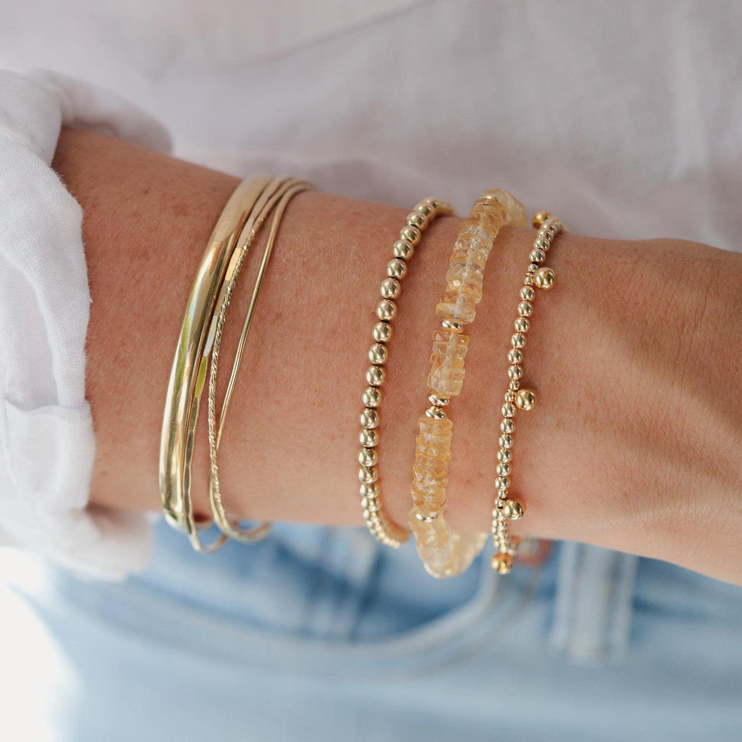 Radiant citrine heishi bracelet by Earthly Abundance featuring polished yellow gemstone beads on a stretchy cord.