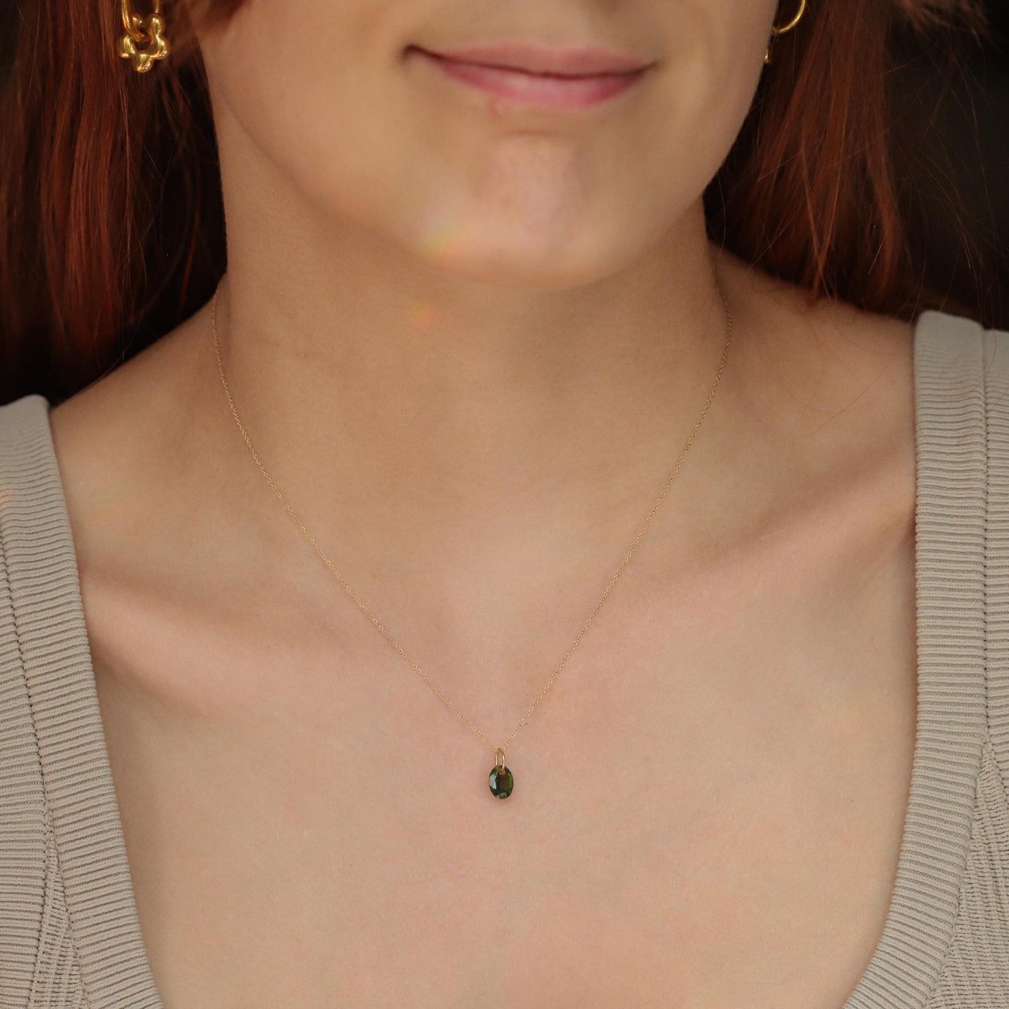 Blue sapphire pendant necklace in 14K gold with a delicate chain, featuring a vibrant blue sapphire gemstone.