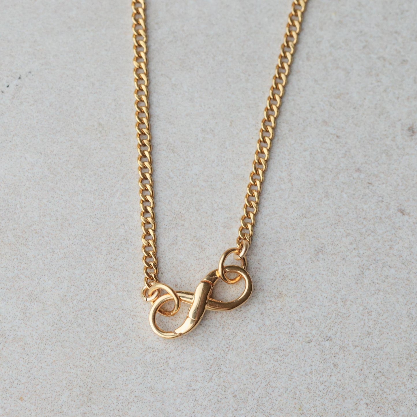 Infinity clasp curb chain necklace featuring peach moonstone and citrine stones, crafted by Earthly Abundance.