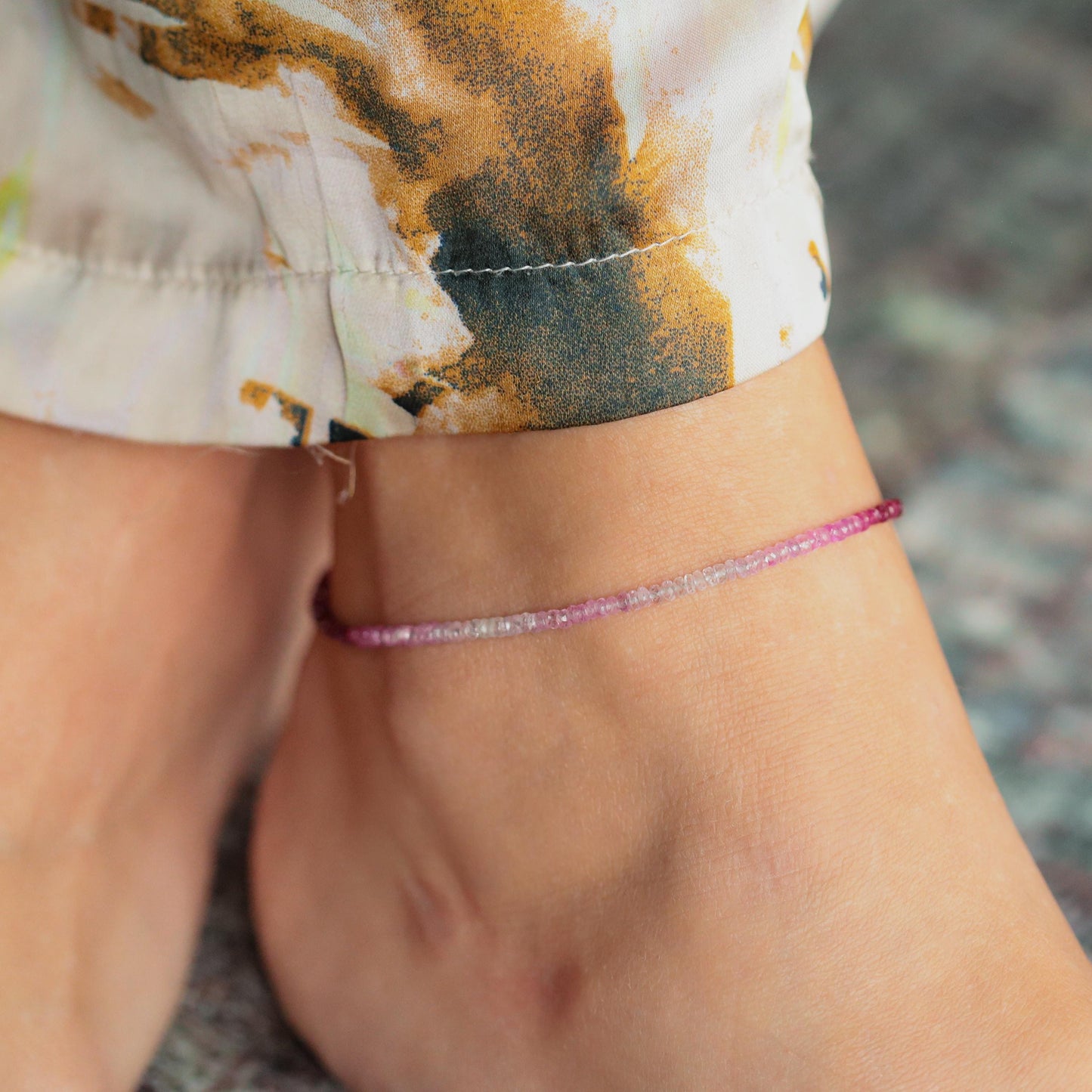 Raspberry Mist Ruby anklet by Earthly Abundance featuring a 14K gold chain with ruby gemstone accents on a white background